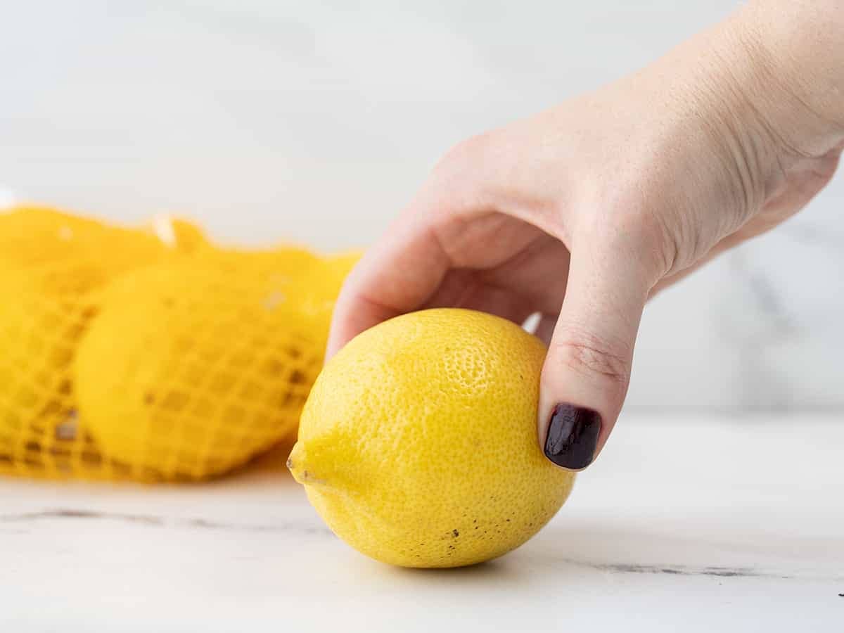 A hand squeezing a lemon
