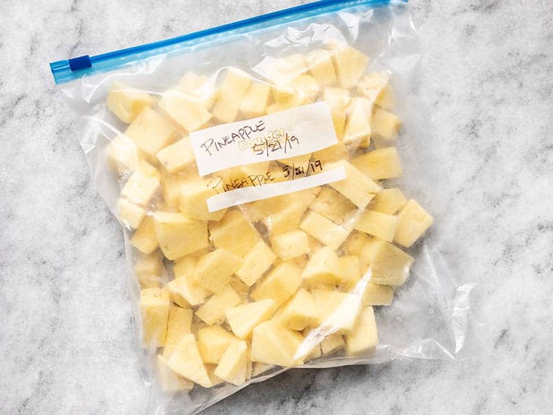 Frozen Pineapple Chunks in a gallon-sized freezer bag.