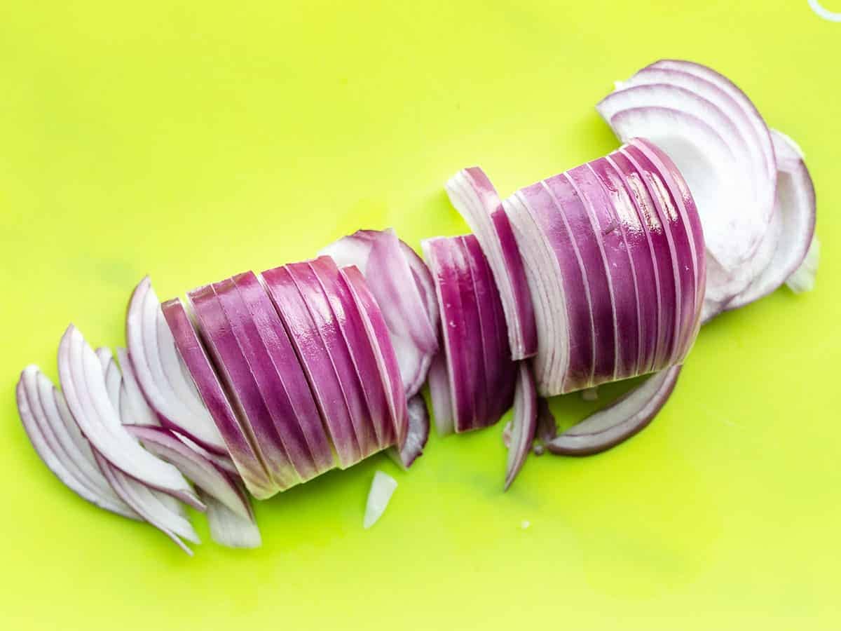 Sliced Red Onion on a green cutting board