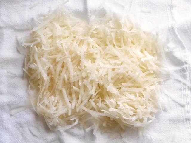 Shredded potatoes on paper towel to get out excess moisture 