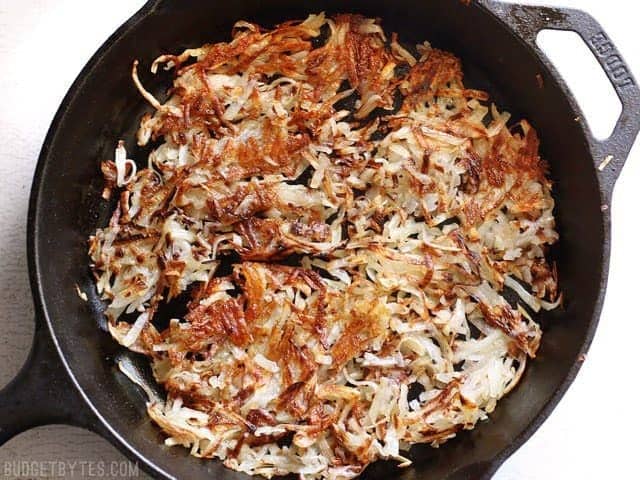 Top view of Crispy Hash Browns in cast iron skillet 