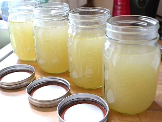 Chicken Broth put into four mason jars 