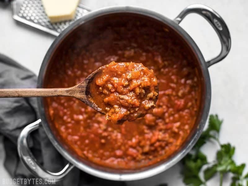 A ladle full of The Best Weeknight Pasta Sauce over the pot