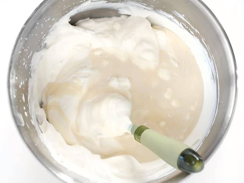 Condensed Milk being folded into the rest of the Whipped Cream