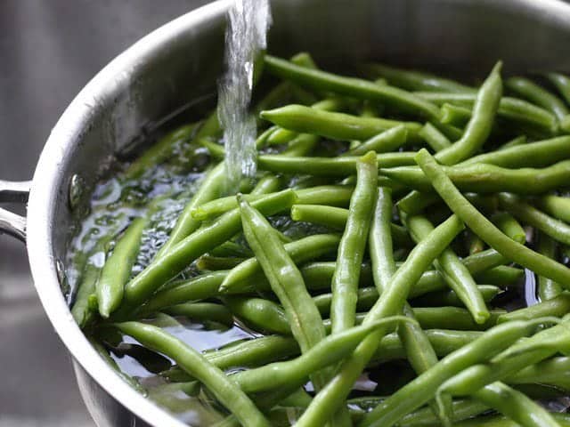Add one inch of water to a skillet full of fresh green beans