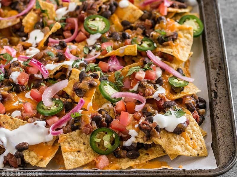Side view of the sheet pan full of Spicy Baked Black Bean Nachos