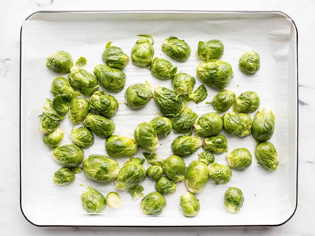 Prepped Brussels sprouts on a baking sheet
