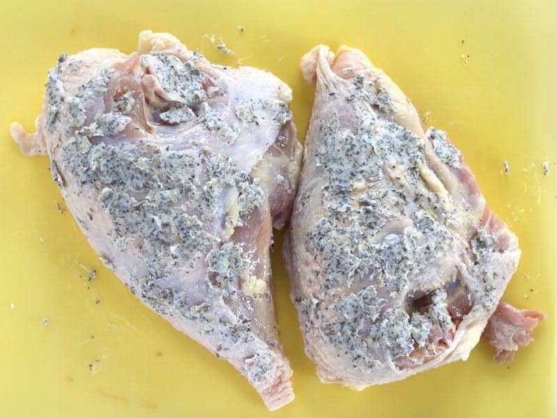 Garlic Herb Butter spread all over the skin of the Chicken