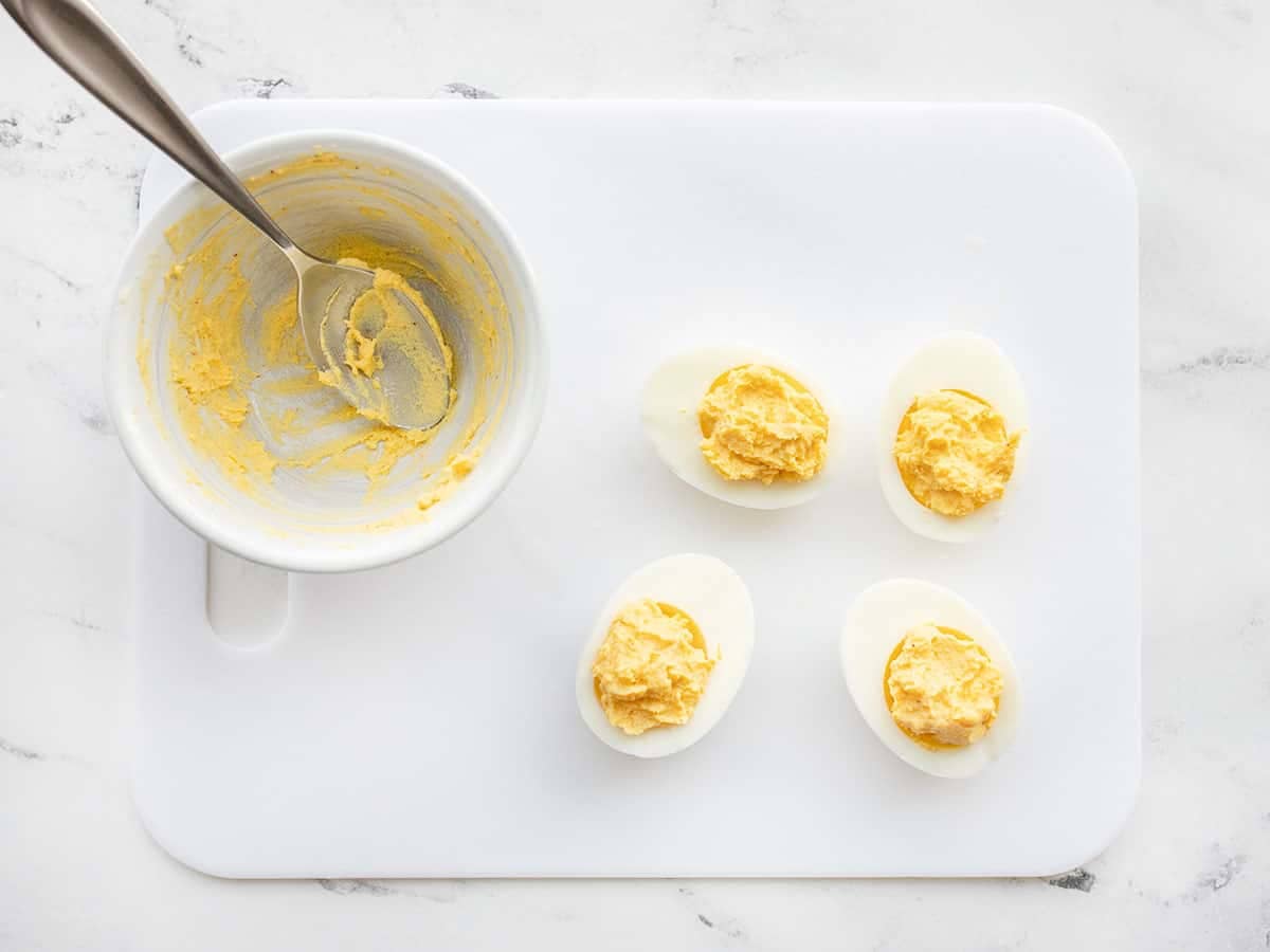 Mashed and seasoned yolk returned to the egg whites