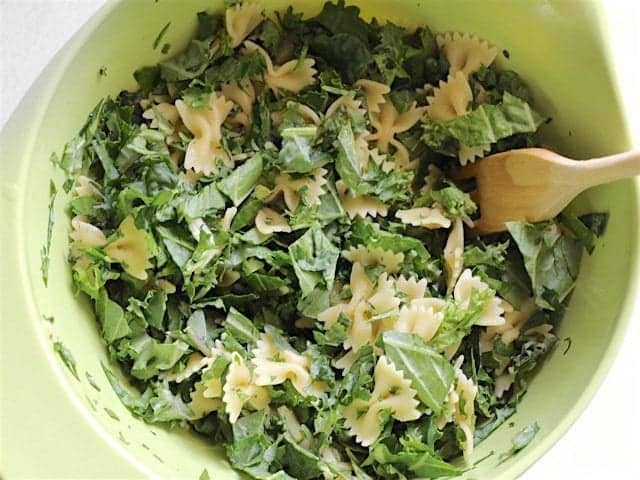 Pasta and Kale in a large bowl with a wooden pasta fork