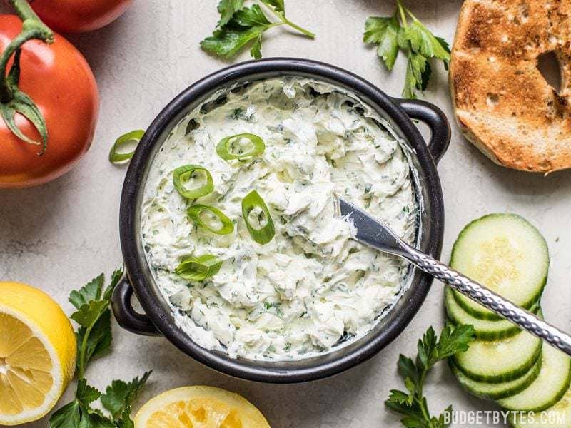 A bowl of finished Scallion Herb Cream Cheese Spread with green onion sprinkled on top