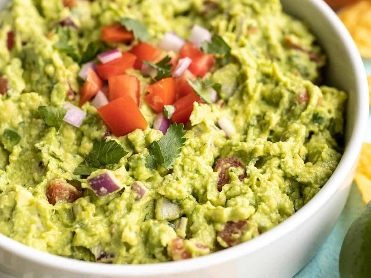 close up side view of a bowl full of guacamole.