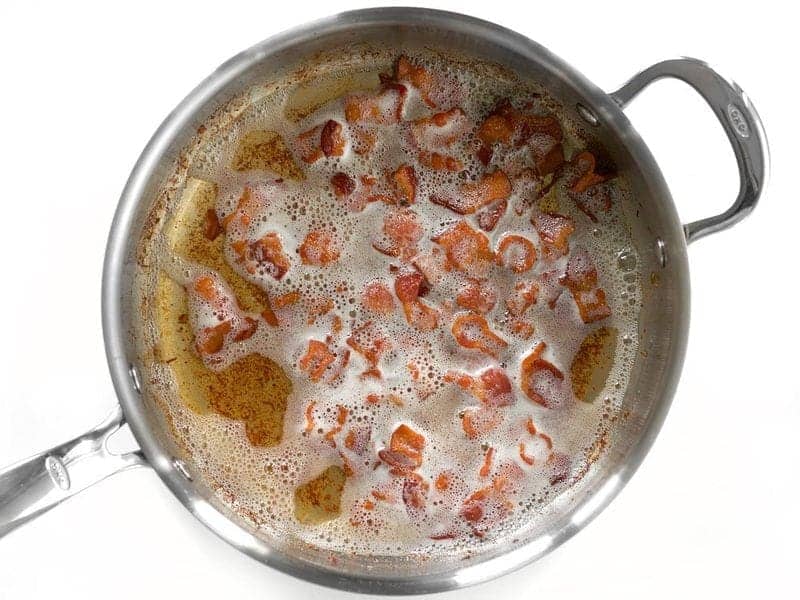 Browned and cooked bacon in skillet 