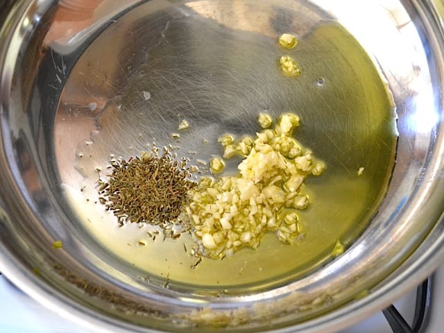 garlic & thyme in skillet with olive oil 