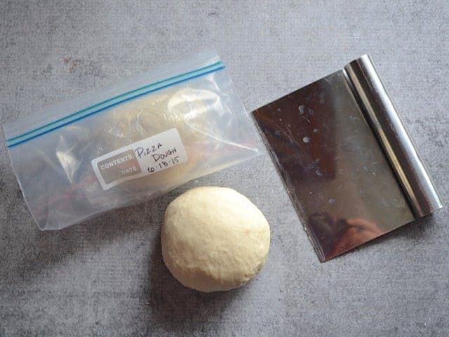 Divided pizza Dough, one half in a freezer bag