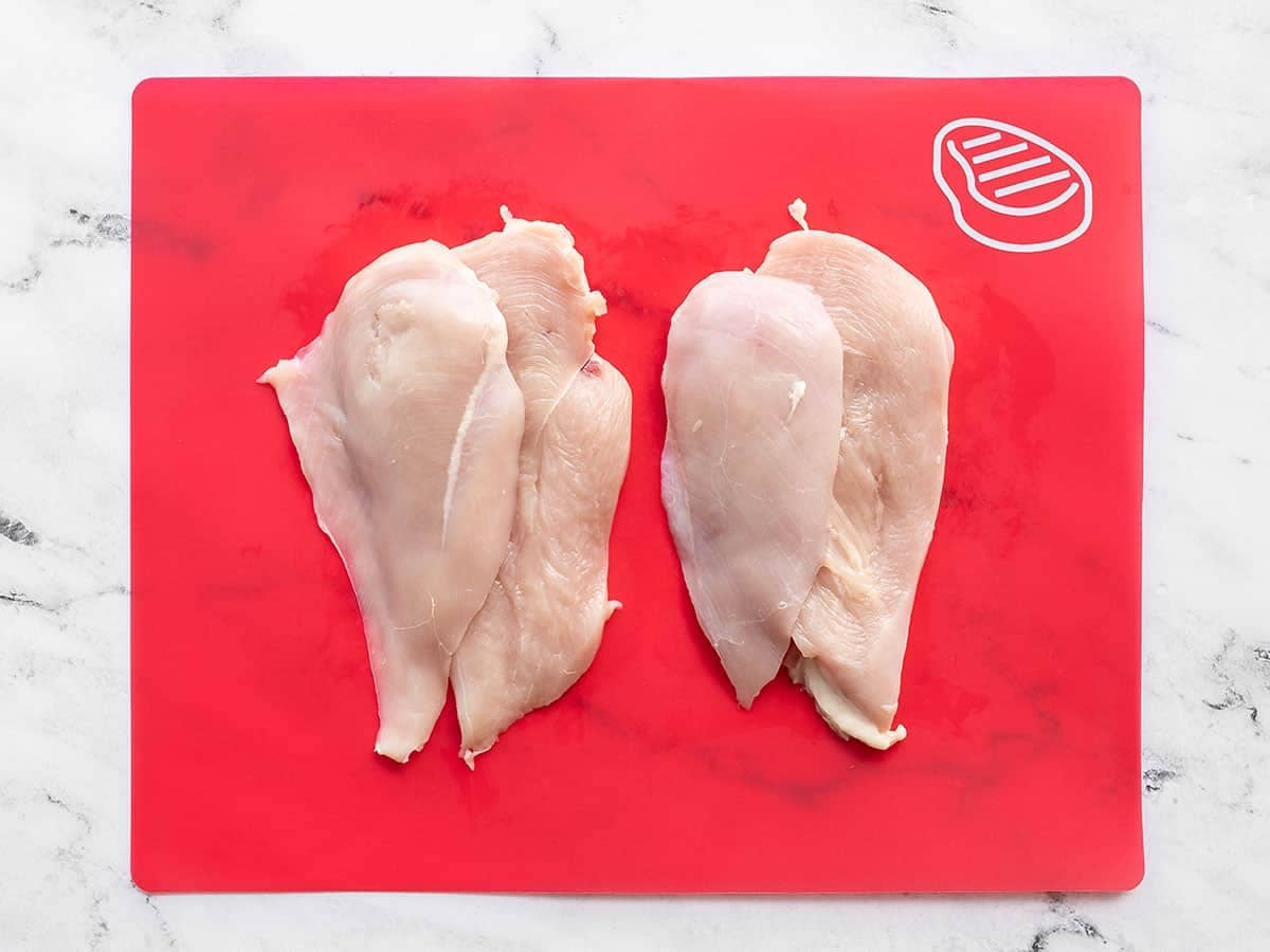 Filleted chicken breasts on a cutting board