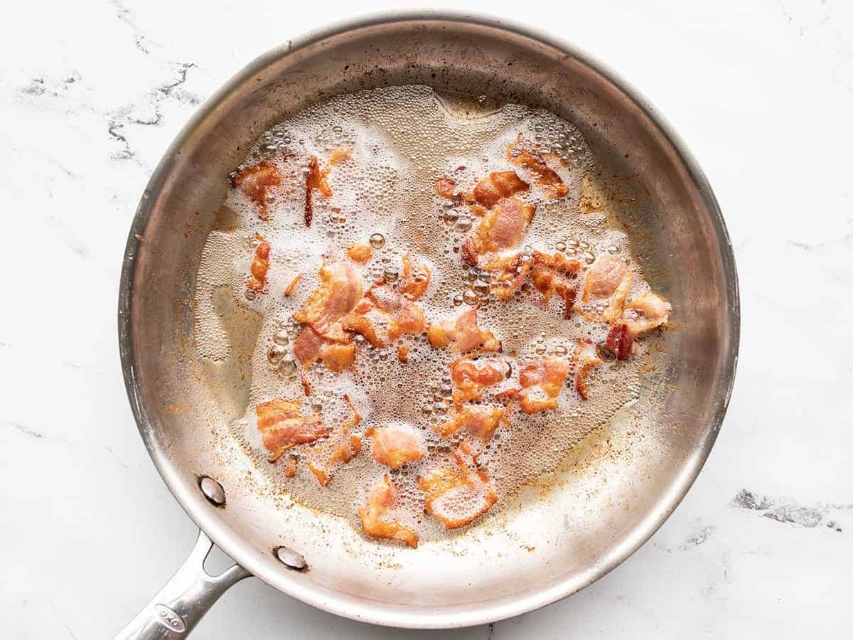 Cooking bacon in a skillet.