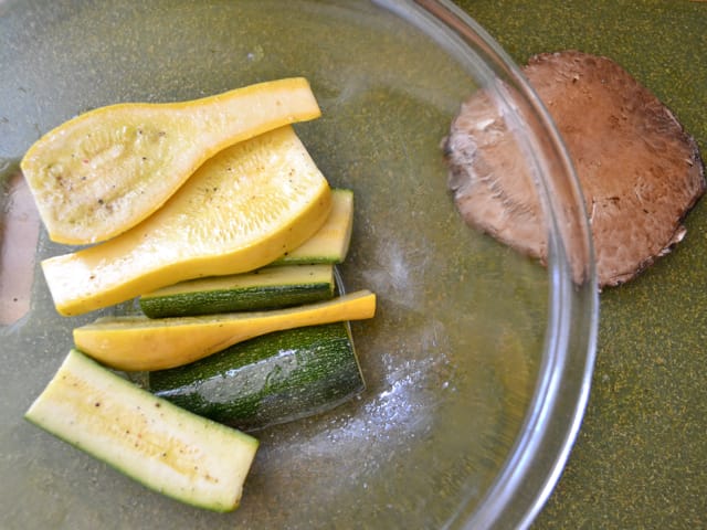 Sliced and oiled vegetables in mixing bowl 