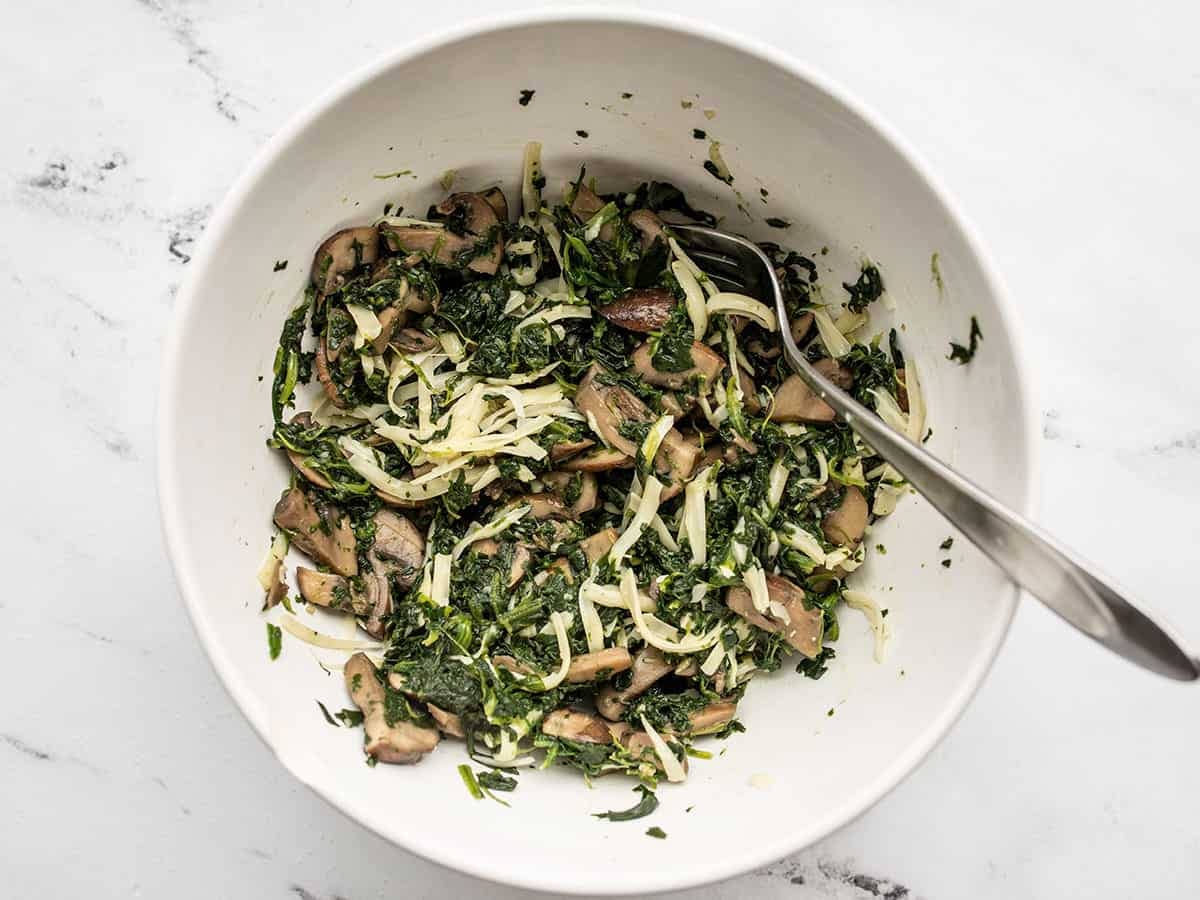 Cheese mixed into spinach and mushrooms.