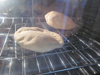 pita dough cooking inside oven (rising)