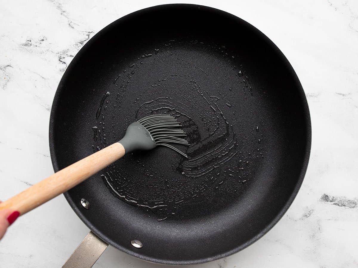 Oil being brushed into a skillet.