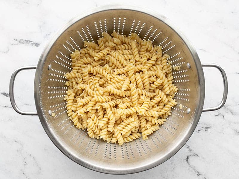 Cooked rotini pasta in a colander
