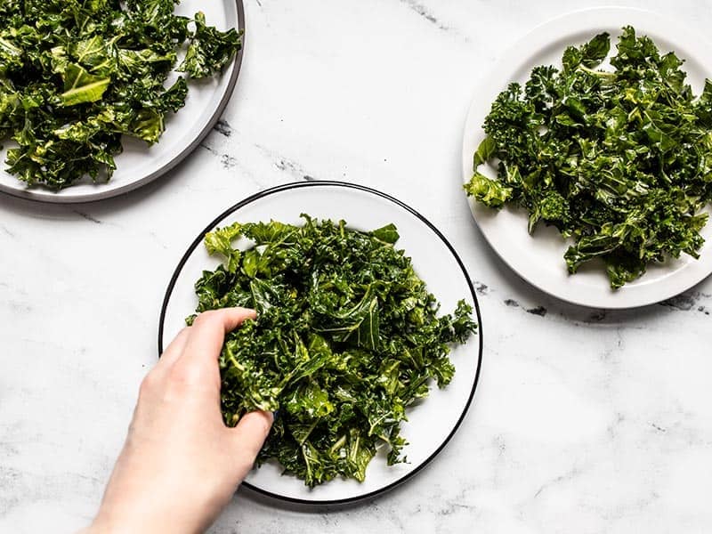 Portion kale onto plates