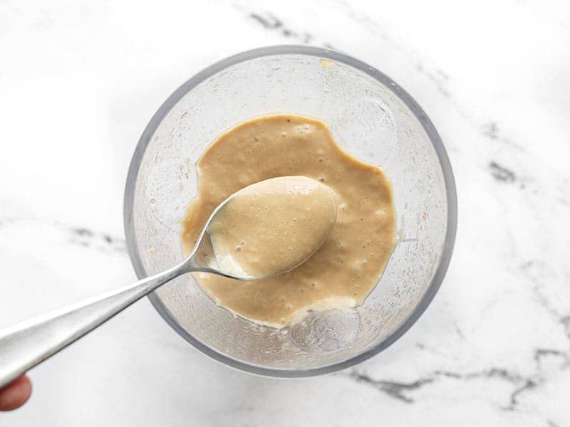 Blended dressing on a spoon in the blender