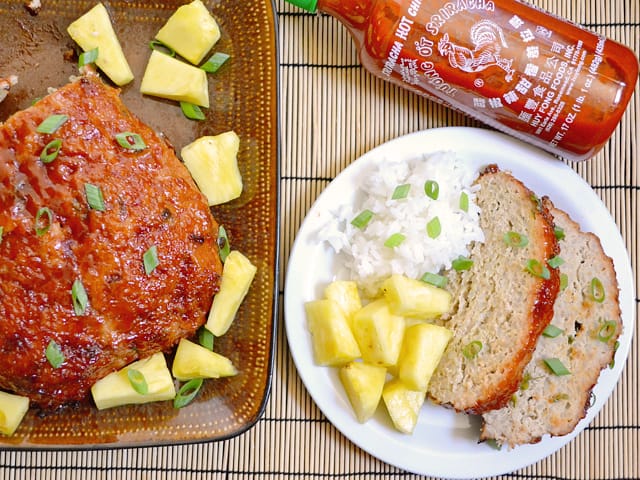 Thai Turkey Meatloaf on pan with two slices and a side of pineapple and rice plated on plate 
