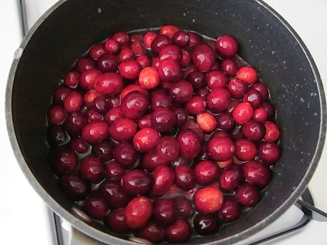 cranberries, water and sugar in pot 