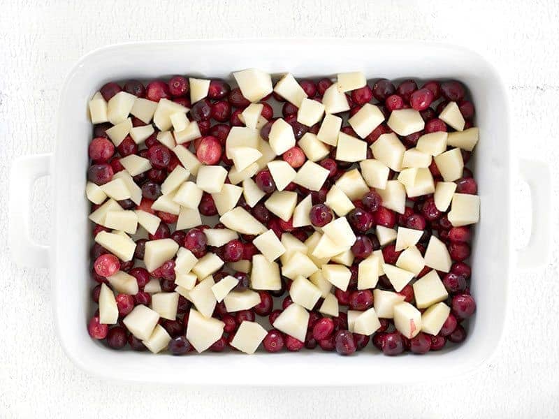 Raw apples and cranberries in the casserole dish