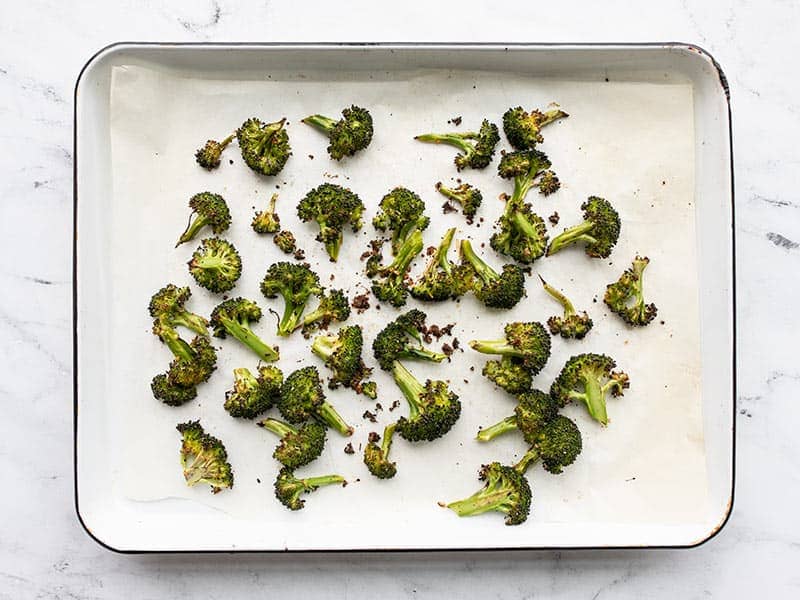 Roasted broccoli florets on the baking sheet
