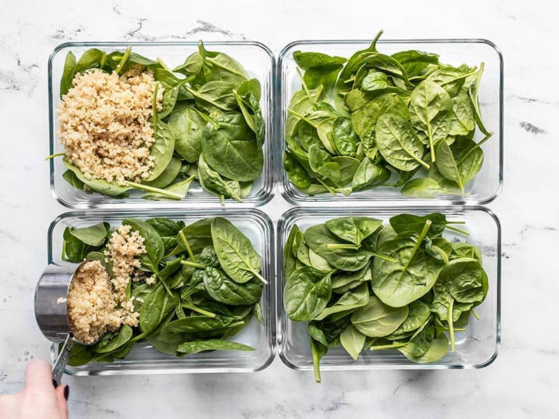 Add spinach and quinoa to meal prep containers