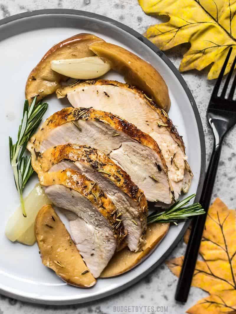 Sliced Cider Roasted Turkey Breast on the plate with apples and onions
