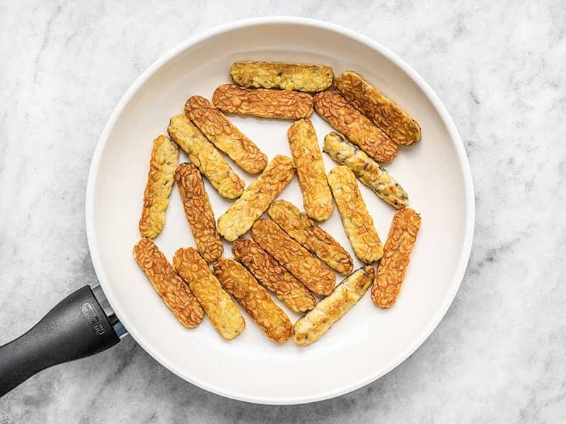 Fried Tempeh in a white ceramic skillet