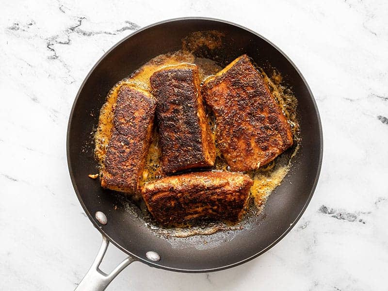 finished blackened salmon in the skillet