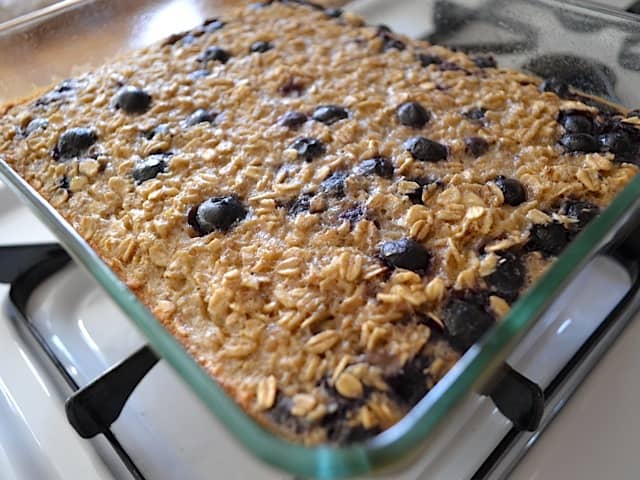 baked blueberry banana oatmeal in baking dish on stove top 