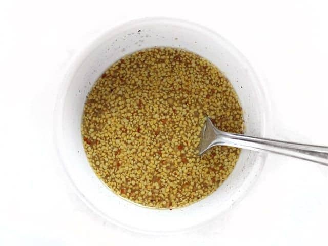 Mustard vinaigrette in a small white bowl