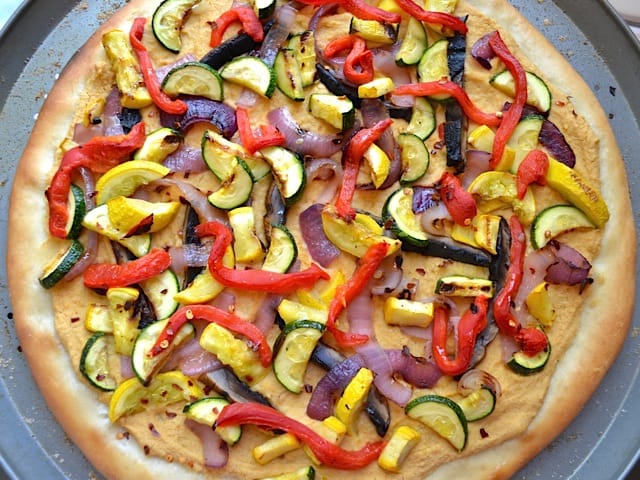 Top view of finished hummus grilled vegetable pizza