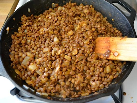 taco seasoned lentils in skillet cooking 
