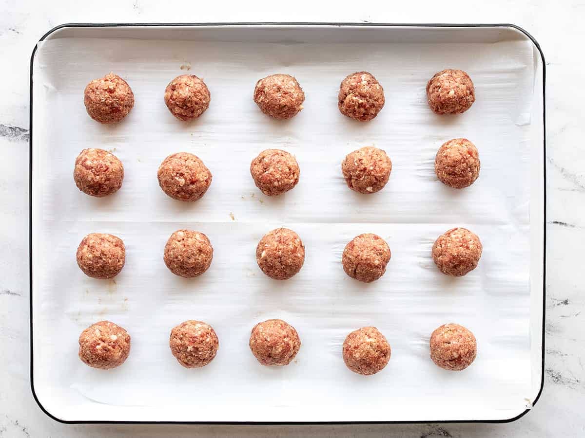 Meatballs on a baking sheet ready to bake