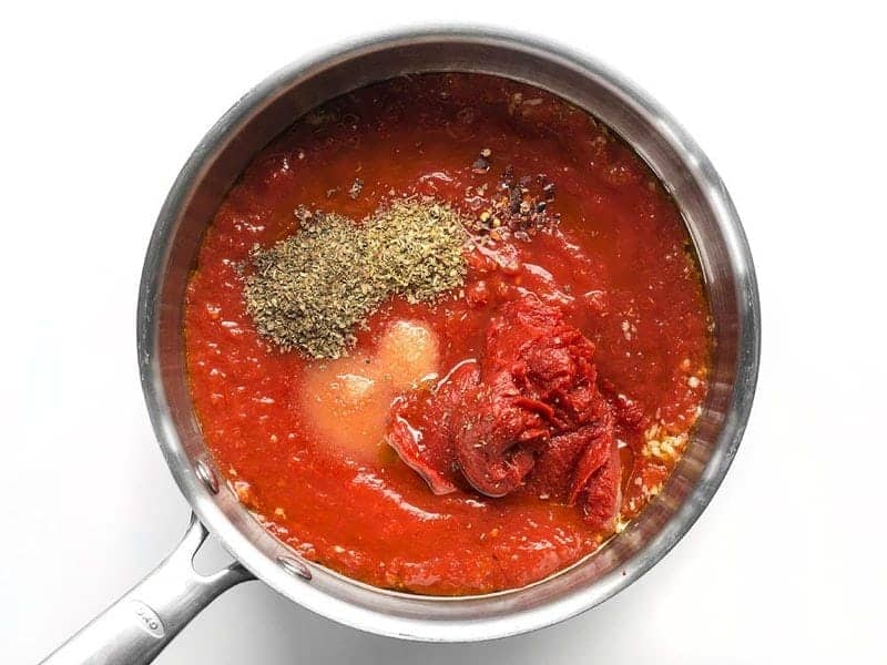 Tomatoes, spices, and herbs in the sauce pot