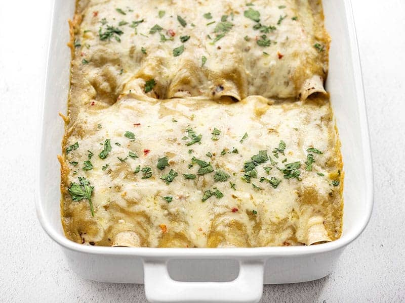 front view of green chile chicken enchiladas in the casserole dish