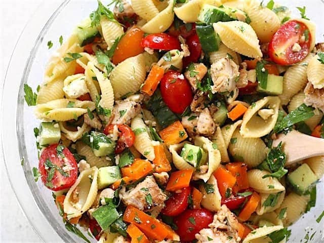 Close up of finished Greek Chicken Pasta Salad in the glass bowl